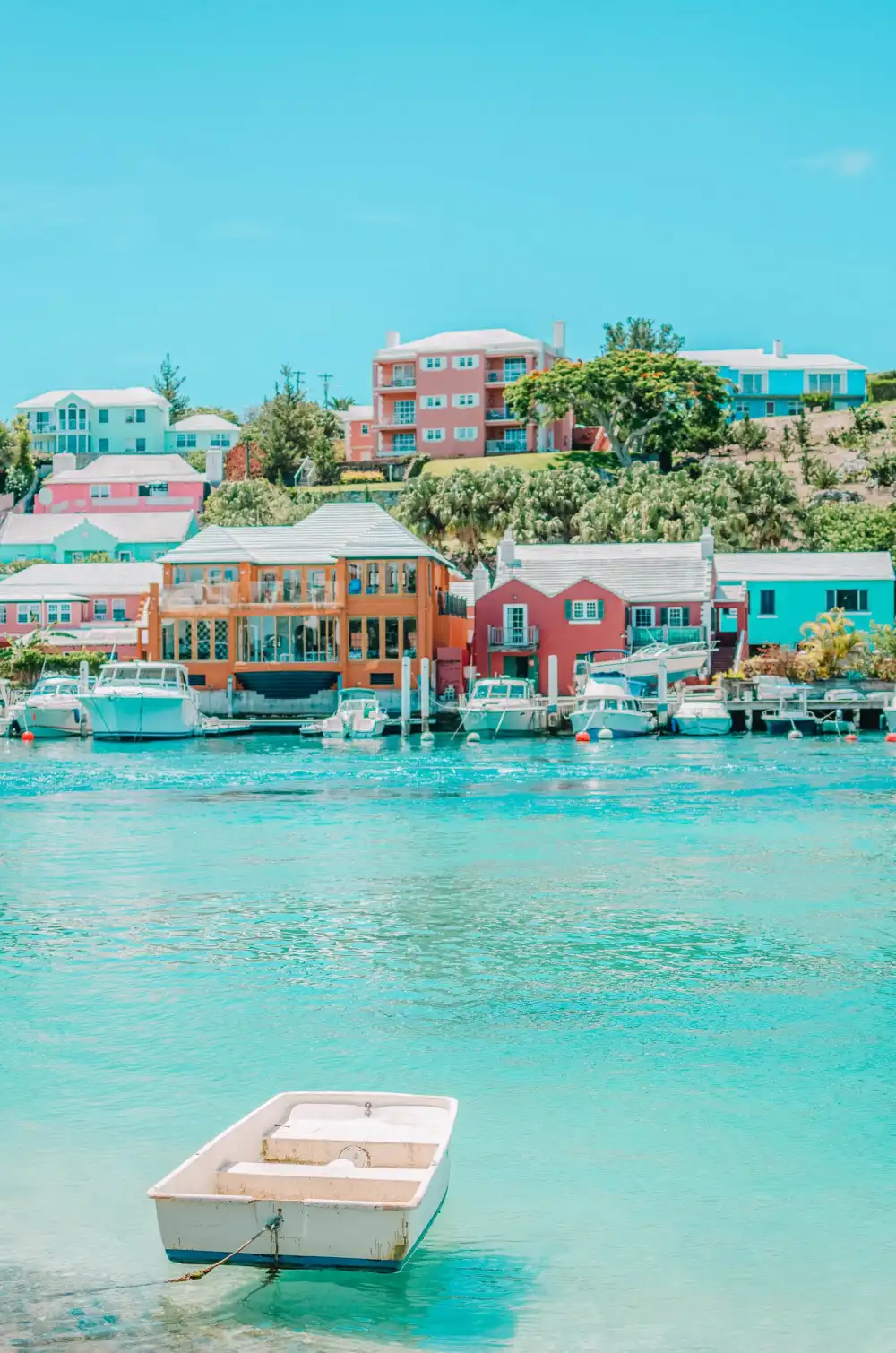 Colorful Bermudian homes overlooking turquoise harbor water
